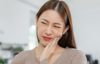 A woman suffering from dental pain.